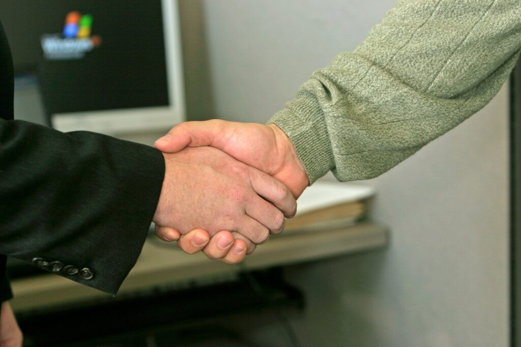 salesperson shaking hands with a client
